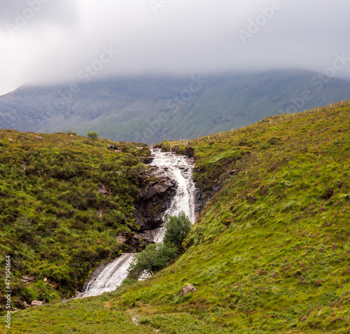 Impressive waterfall and low cloud over mountain on the Isle of Skye  Scotland  Uk