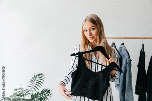 The girl is showing her black Friday purchase - black top in the closet