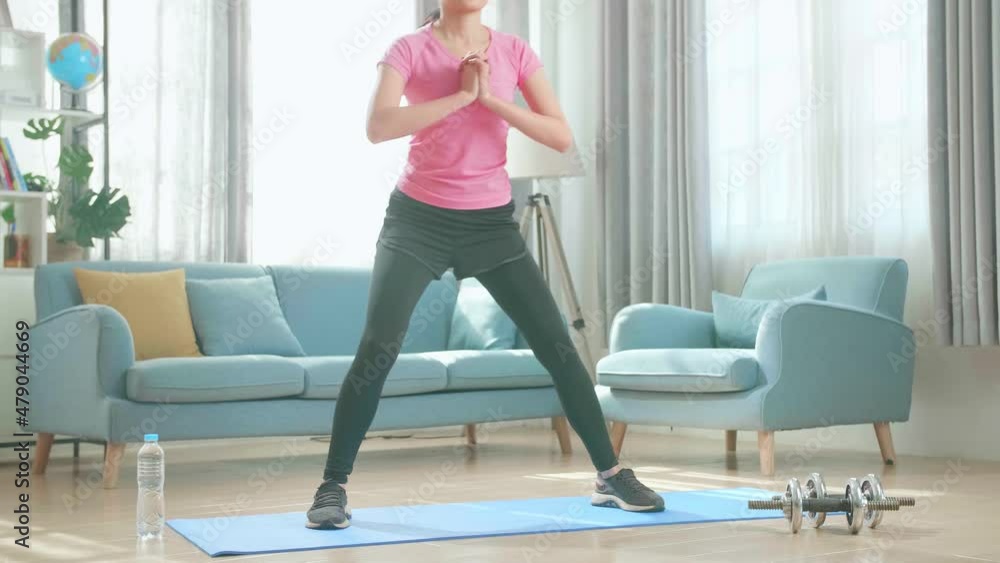 Asian Woman Exercising At Home, Stretching Her Legs
Asian Woman Exercising At Home, Stretching Her Legs