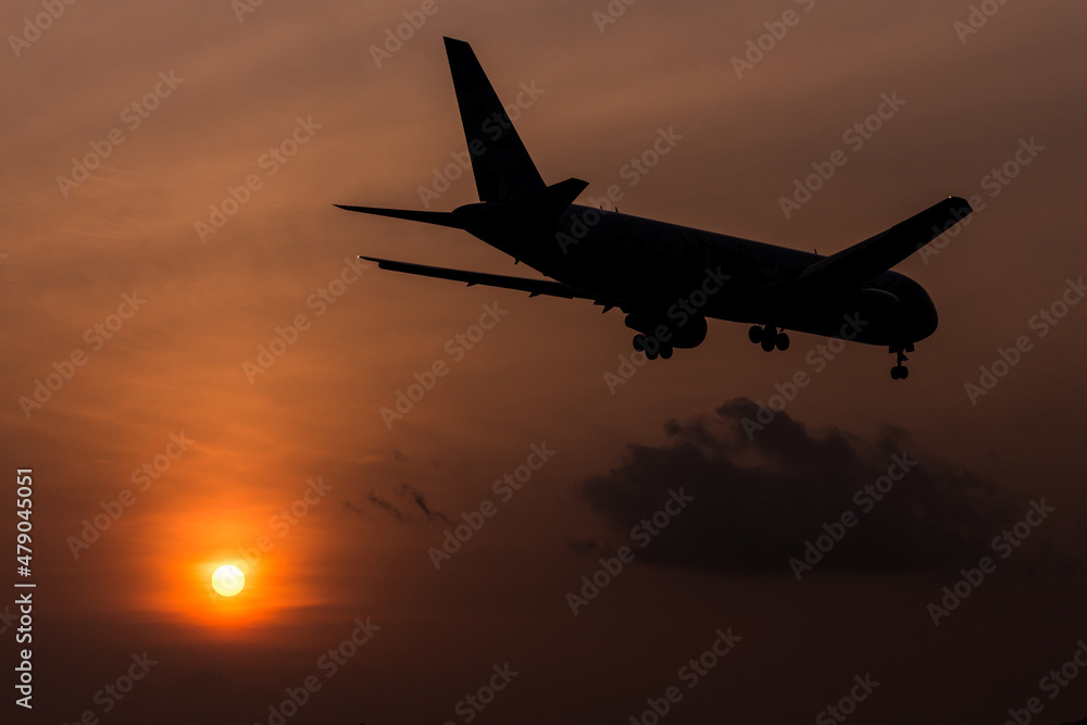 airplane landing at sunset