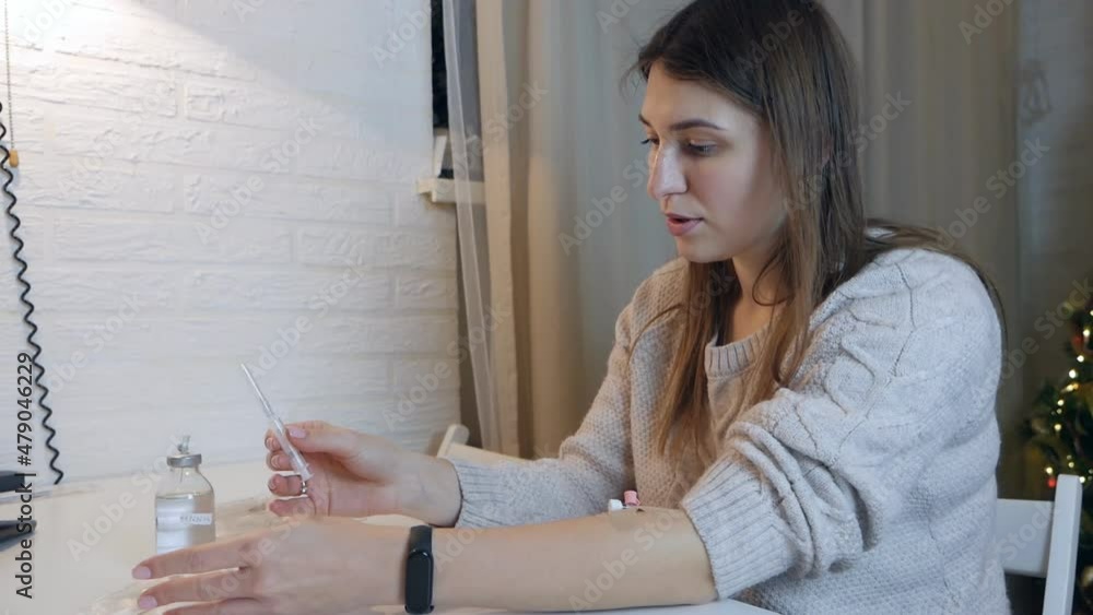 Treatment at home. Young woman prepares a syringe for injection Treatment at home. Young woman prepares a syringe for injection