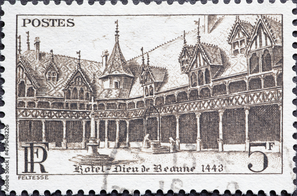 France - circa 1941: A postage stamp from France showing the historic Hôtel-Dieu de Beaune 1443