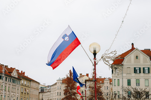 Slovenia flag waving in a cloudy day in Drava Bridge, Maribor