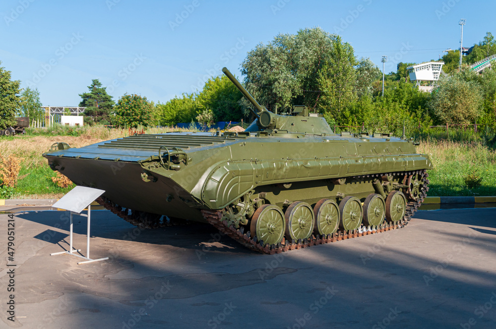 Infantry fighting vehicle. BMP 1 on display in victory park nizhny Novgorod. Standing on the asphalt against the backdrop of green trees and blue sky. High quality photo
