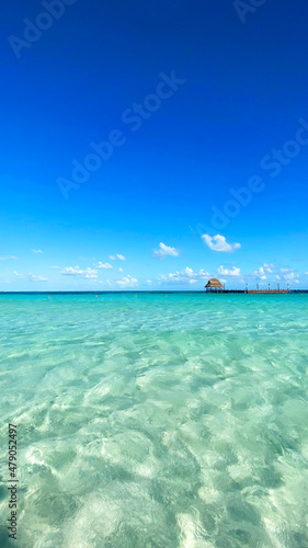 Isla Mujeres beach with blue sky and clear water.