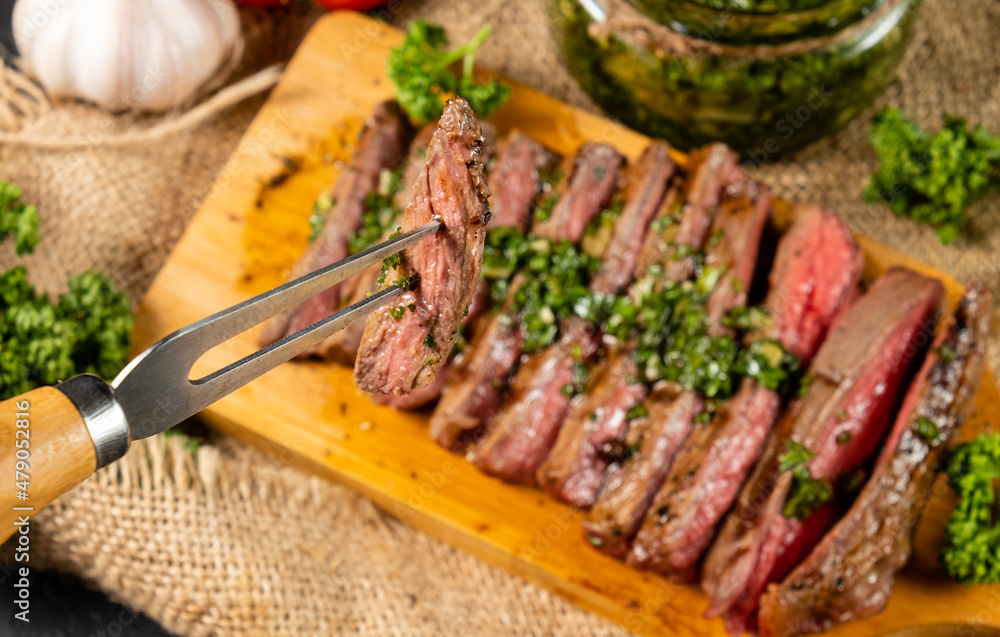 A piece of steak strung on a fork close-up.