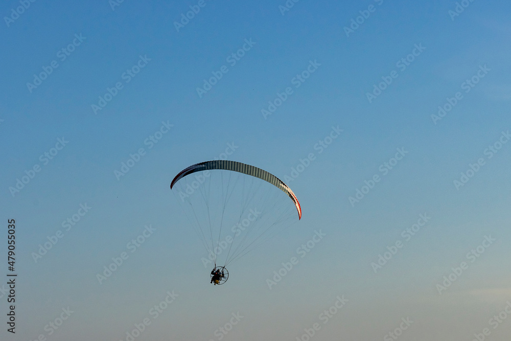 Paraglider with motor against blue sky Paraglider with motor against blue sky