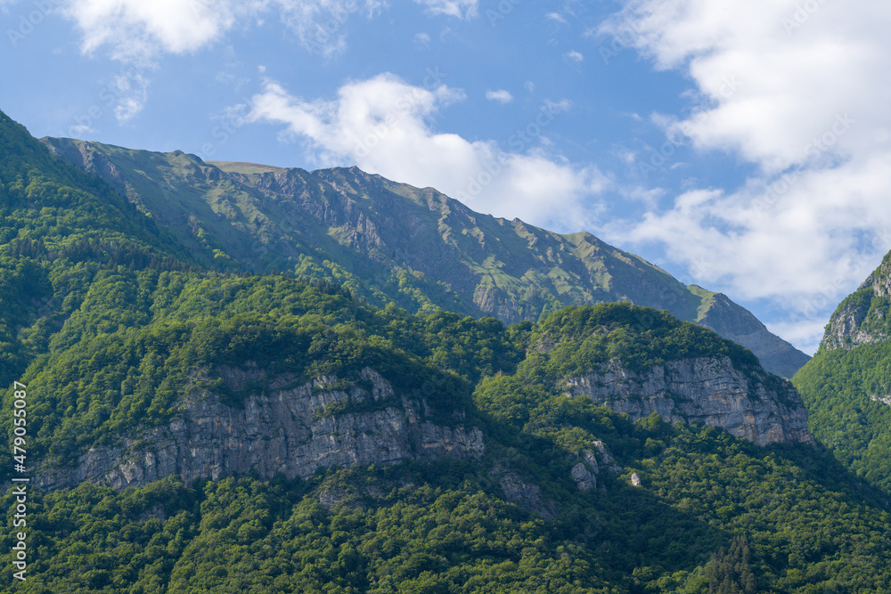 Fototapeta premium White clouds above the Massif des Bauges in Europe, France, Isere, the Alps, in summer, on a sunny day.