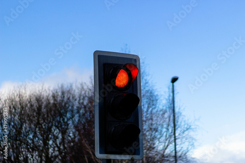 red traffic light on a sky