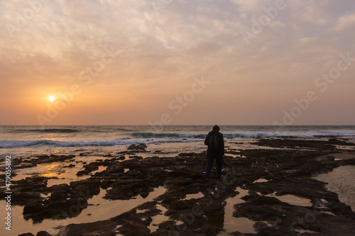 Man on the beach during sunset