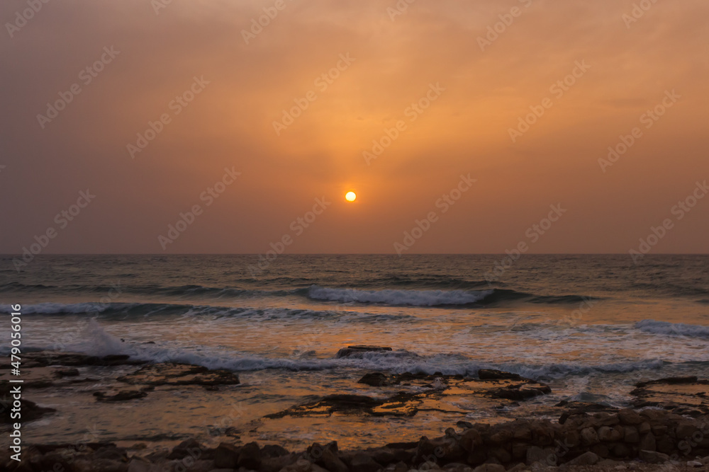 foggy sunset on the beach near haifa