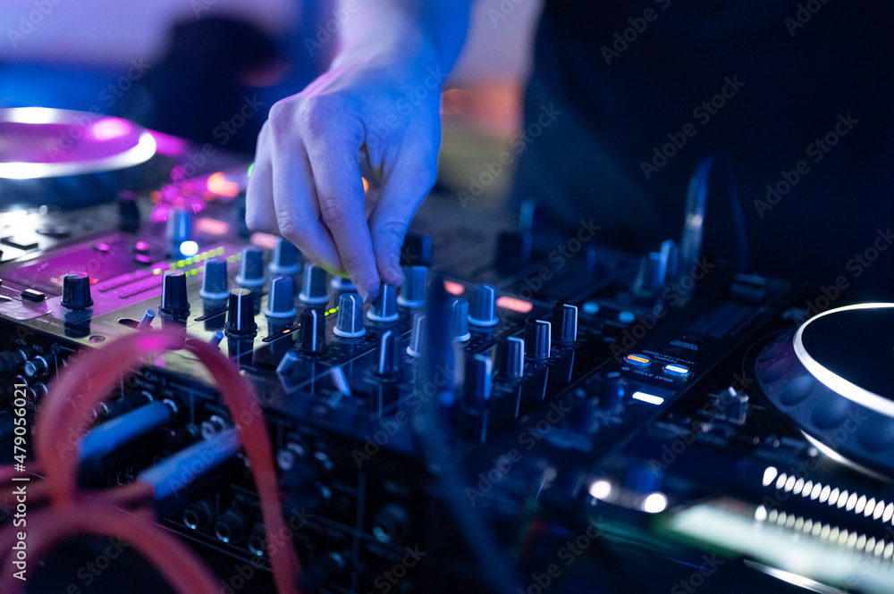 Dj mixing at party festival with light and smoke in background - Summer nightlife view of disco club inside.High quality photography. Dj mixing at party festival with light and smoke in background - Summer nightlife view of disco club inside.High quality photography.