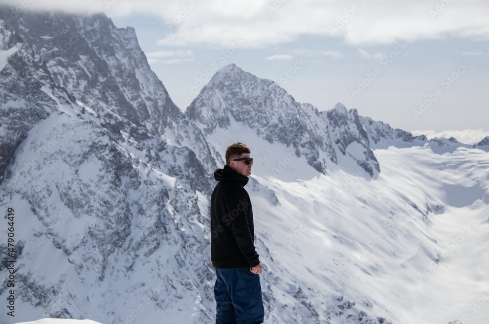 Portrait of a man on top of a snowy mountain