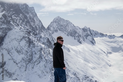 Portrait of a man on top of a snowy mountain