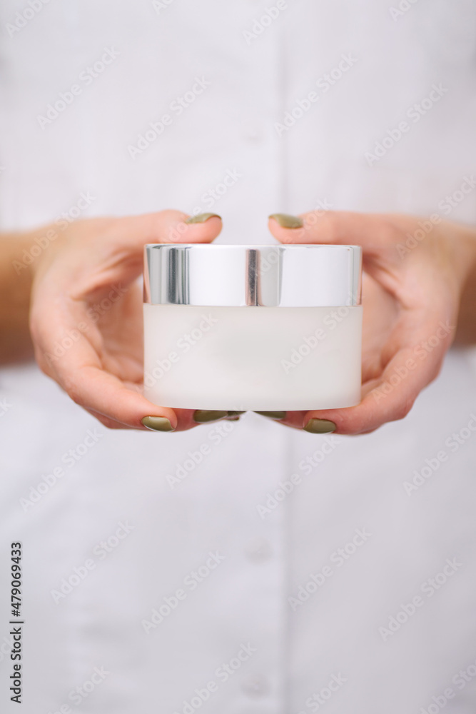 Close-up of a product in a hands of female professional beauty doctor. Close-up of a product in a hands of female professional beauty doctor.
