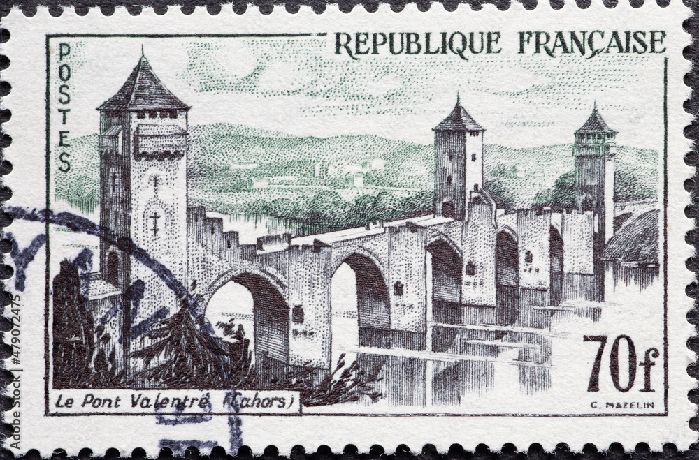 France - circa 1957: A post stamp from France showing the historic bridge from Valentre Bridge, Cahors