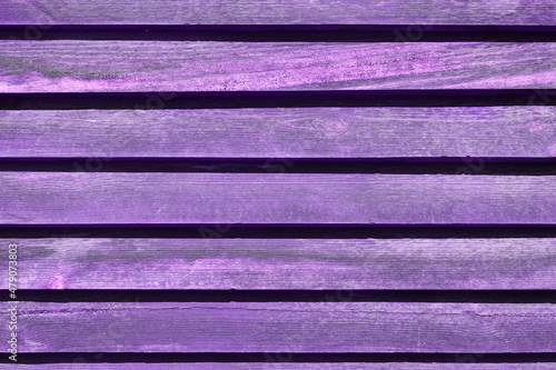 Purple-violet painted boards of an old village house. Texture and Background. High quality photo