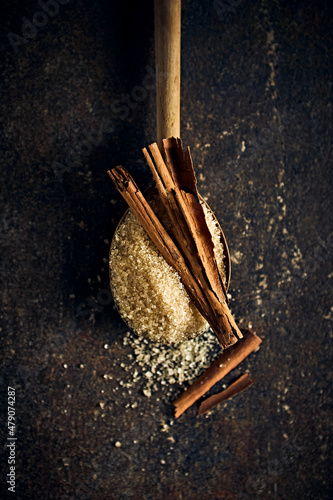 Brown sugar and cinnamon sticks on wooden spoon