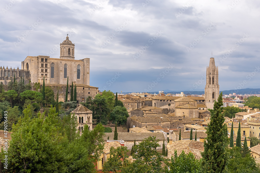 View from the protective wall on the medieval city of Girona with the Cathedral of St. Maria and the Church of St. Feliu. Girona, Catalonia, Spain.