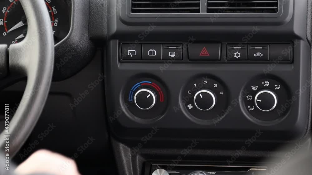 a man presses a key to operate the wipers and wash the windshield a man presses a key to operate the wipers and wash the windshield