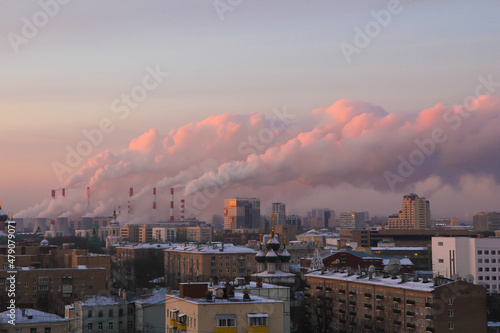 Morning cityscape with the picturesque smoke from the thermal power plant pipes.