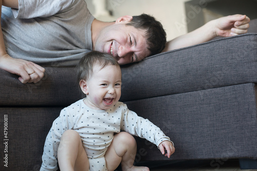 Baby enjoys playing with dad