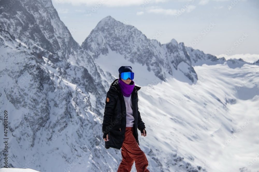 Portrait of a girl on top of a snowy mountain