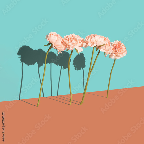 Fake flowers surreal scene on a two tone pastel background. Artificial universe love minimal concept.