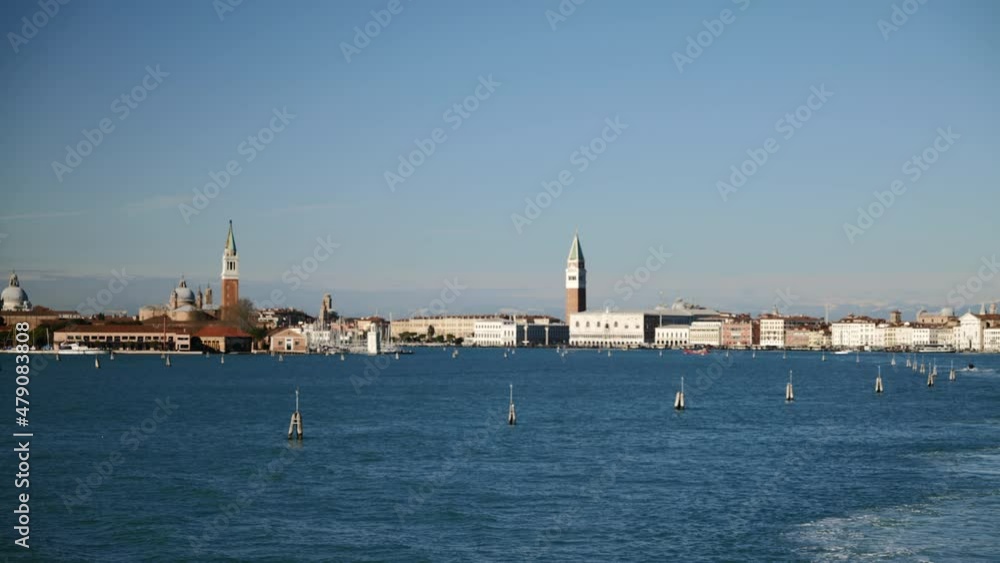 Venice, Italy - January 2022 - Traveling on the ferry that transports cars, along the Giudecca canal, among the historic buildings of the lagoon city Venice, Italy - January 2022 - Traveling on the ferry that transports cars, along the Giudecca canal, among the historic buildings of the lagoon city