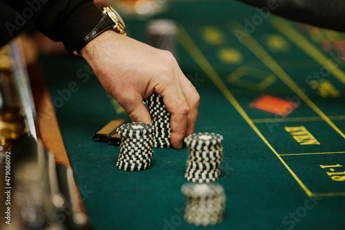 hand and chips on roulette table