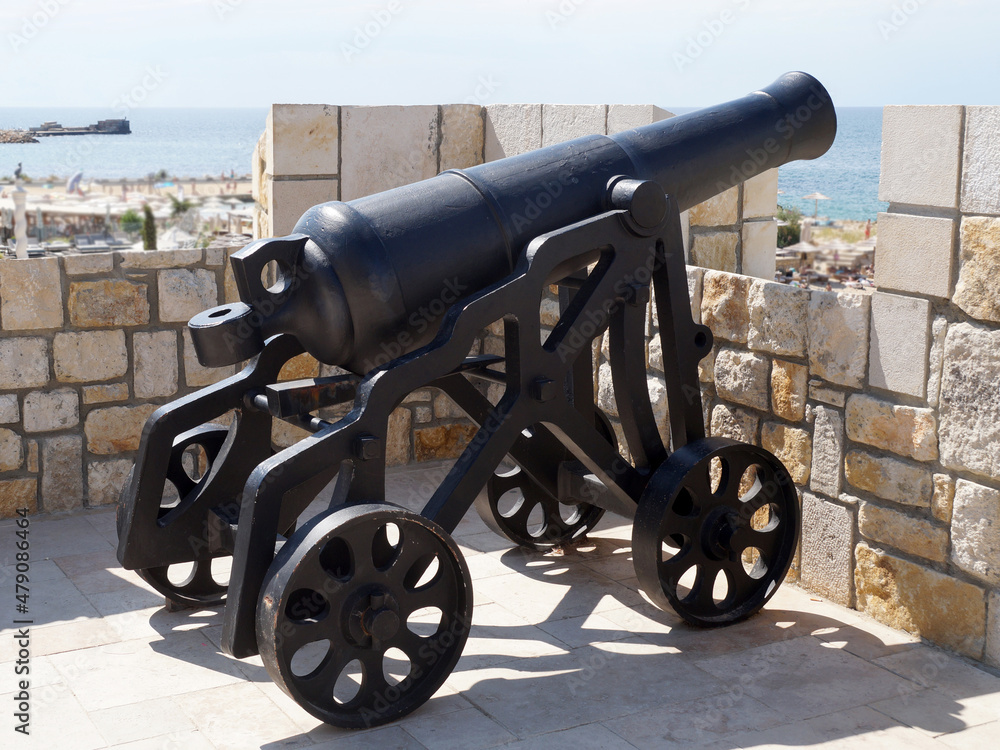 antique cannon aimed at the sea on the fortress wall antique cannon aimed at the sea on the fortress wall