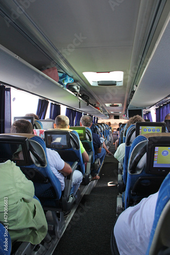 happy family riding in travel bus. Row of seats with people on the bus