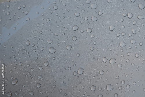 Droplets of rain water on a freshly washed and waxed car