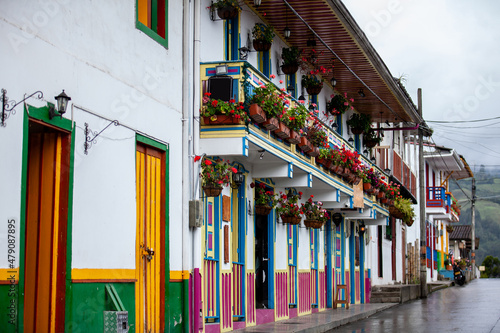 Beautiful traditional wooden balcony of the rural areas in Colombia decorated with flowering plants in the small town of Salento located at the region of Quindio photo
