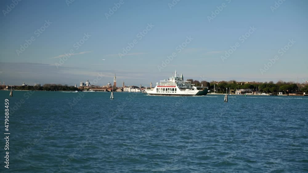 Venice, Italy - January 2022 - Traveling on the ferry that transports cars, along the Giudecca canal, among the historic buildings of the lagoon city Venice, Italy - January 2022 - Traveling on the ferry that transports cars, along the Giudecca canal, among the historic buildings of the lagoon city