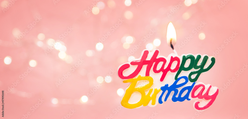 Happy birthday candle on pink background with bokeh Happy birthday candle on pink background with bokeh