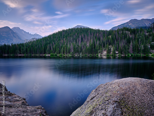 Long exposure of Bear Lake surrounded by the pine trees and the Rocky Mountains