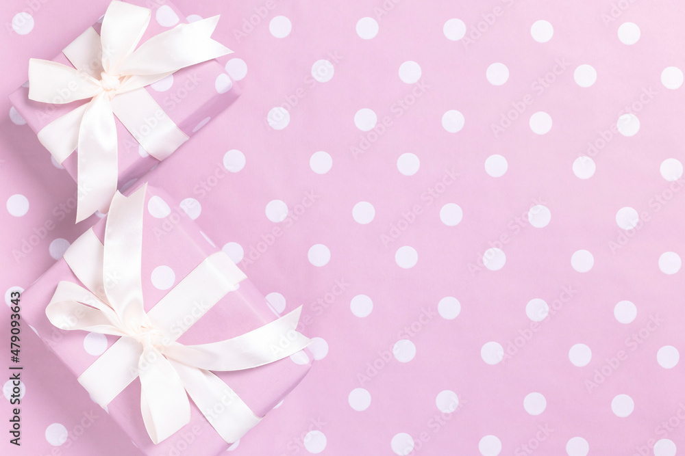Pink gift boxes with polka dots on a pink background. Top view.