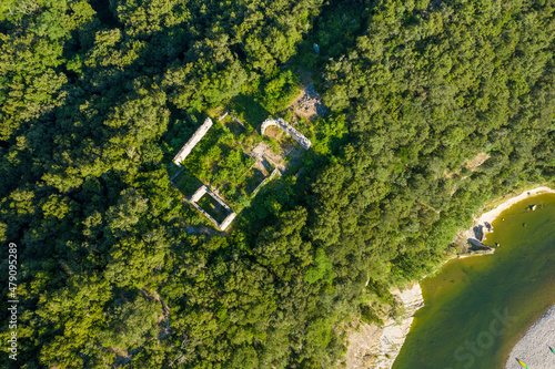 The ruins of a building in the middle of the Gorges de lArdeche in Europe, France, Ardeche, in summer, on a sunny day. photo