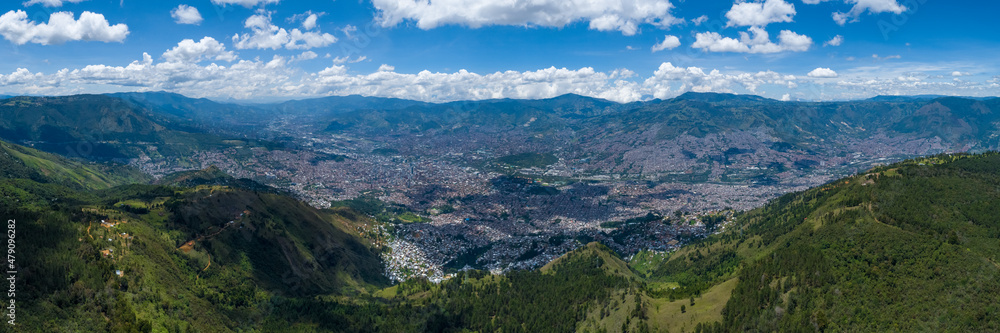 Panoramic View of the City of Medellin, Colombia Surrounded by Green Mountains on a Sunny Day