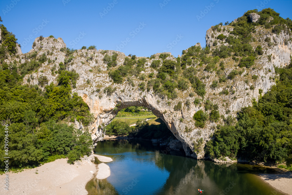 Fototapeta premium The river flows under the Pont dArc in the Gorges de lArdeche in Europe, France, Ardeche, in summer, on a sunny day.