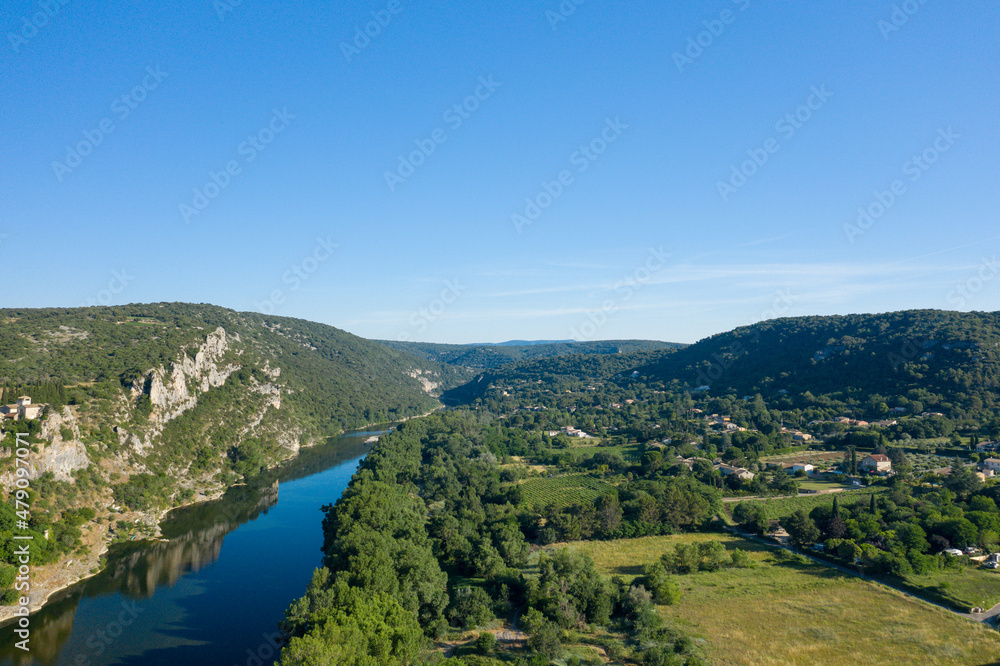 The Ardeche flows near the town of Aigueze and its countryside in Europe, France, Ardeche, in summer, on a sunny day. The Ardeche flows near the town of Aigueze and its countryside in Europe, France, Ardeche, in summer, on a sunny day.