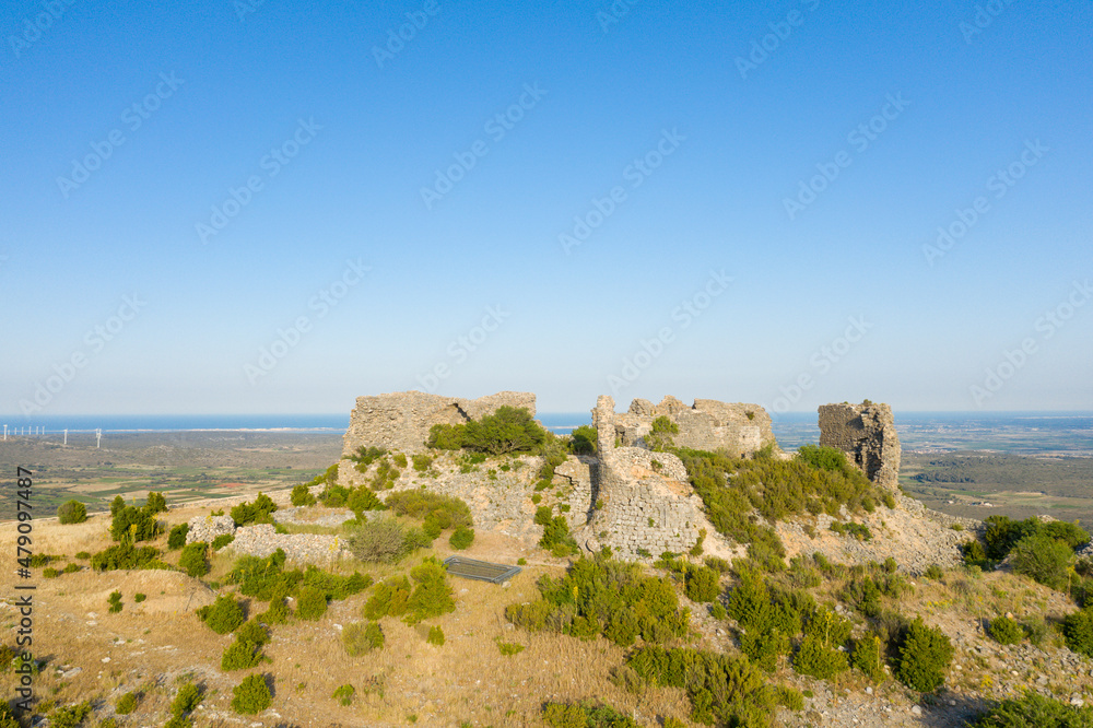 The ruined medieval Chateau of Opoul Perillos in Europe, France, Occitanie, Pyrenees Orientales in summer on a sunny day.