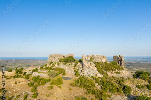 The ruined medieval Chateau of Opoul Perillos in Europe, France, Occitanie, Pyrenees Orientales in summer on a sunny day.