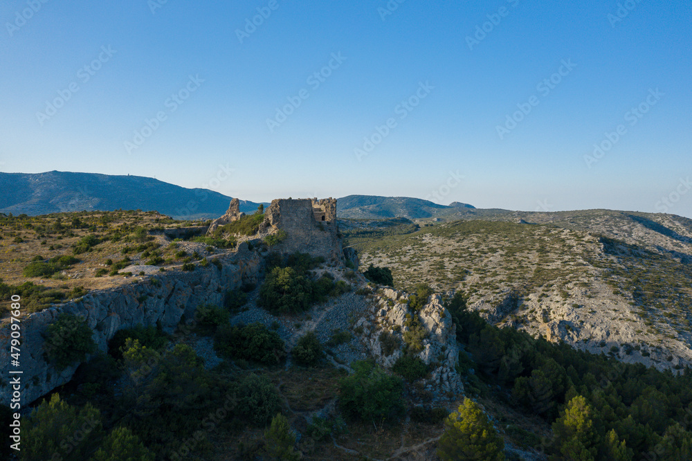 The Chateau de Opoul Perillos in the arid countryside of the south of Europe, France, Occitanie, the Pyrenees Orientales, in the summer on a sunny day.