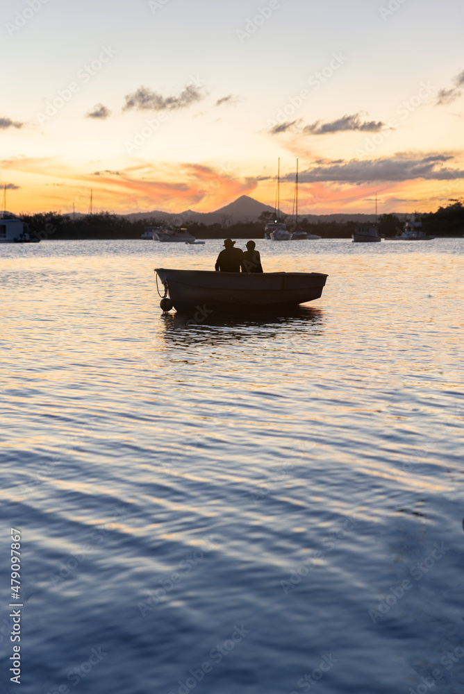Silhouette of Couple Sitting in a Boat Looking the Sunset in Noosa River,Queensland,Australia