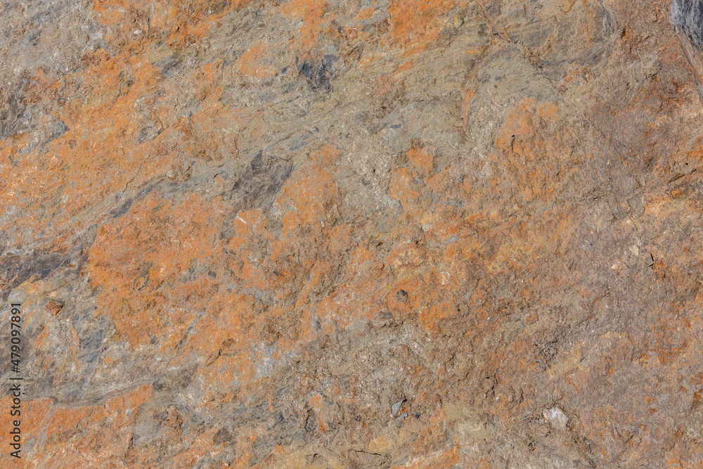 The surface has a rough stone texture with a rusty tinge. Background for designers. The surface has a rough stone texture with a rusty tinge. Background for designers.