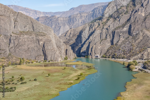 A beautiful valley in the mountains and a river with turquoise water. Natural landscape.