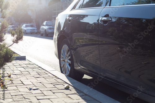 Wallpaper Mural A black passenger car parked on the street. Close-up. Torontodigital.ca