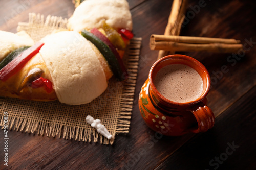 Traditional Kings day cake also called Rosca de Reyes, roscon, Epiphany Cake and with a clay Jarrito. Mexican tradition on January 5th photo